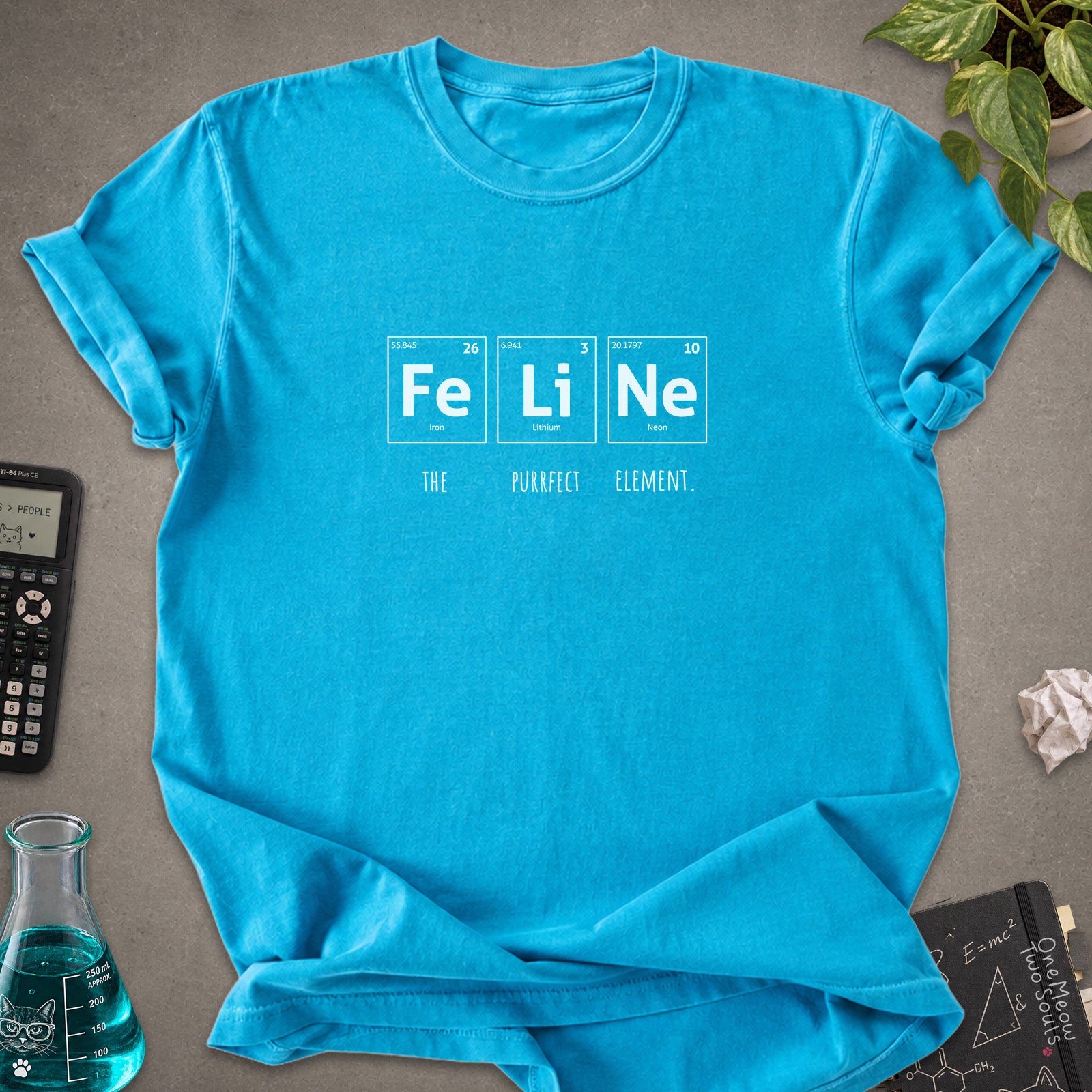 Sapphire  colored Comfort Colors 1717 cotton T-shirt, presenting a "FeLiNe The Purrfect Lelement" funny Chemistry cat design. One Meow Two Souls brand.