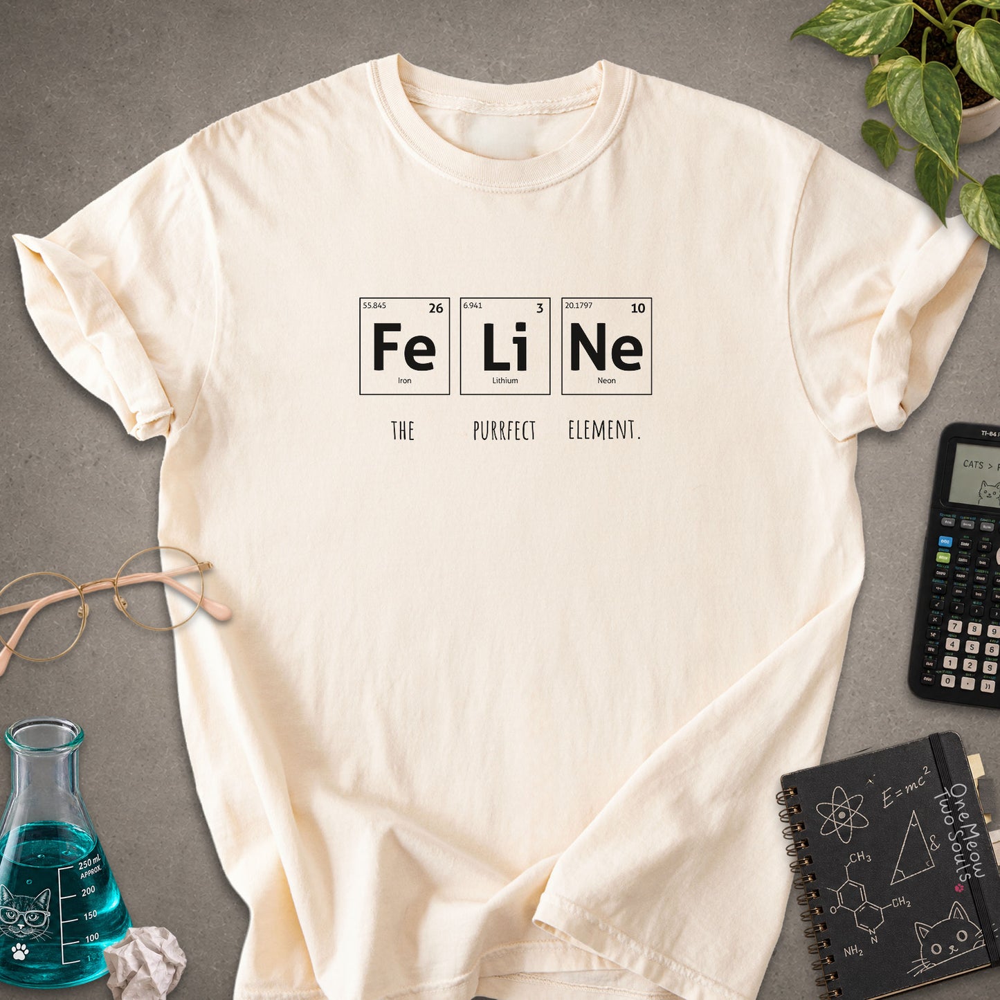 Ivory colored Comfort Colors 1717 cotton T-shirt, presenting a "FeLiNe The Purrfect Lelement" funny Chemistry cat design. One Meow Two Souls brand.