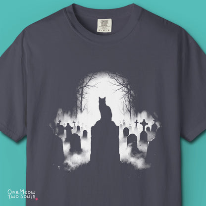 Navy colored Comfort Colors 1717 cotton T-shirt, featuring a spooky graveyard Halloween cat design illustration. One Meow Two Souls brand.