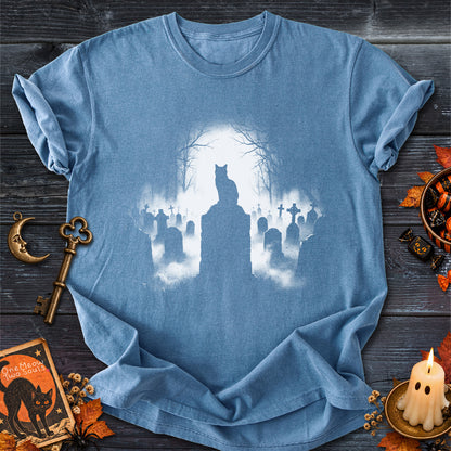Blue Jean colored Comfort Colors 1717 cotton T-shirt, featuring a spooky graveyard Halloween cat design illustration. One Meow Two Souls brand.