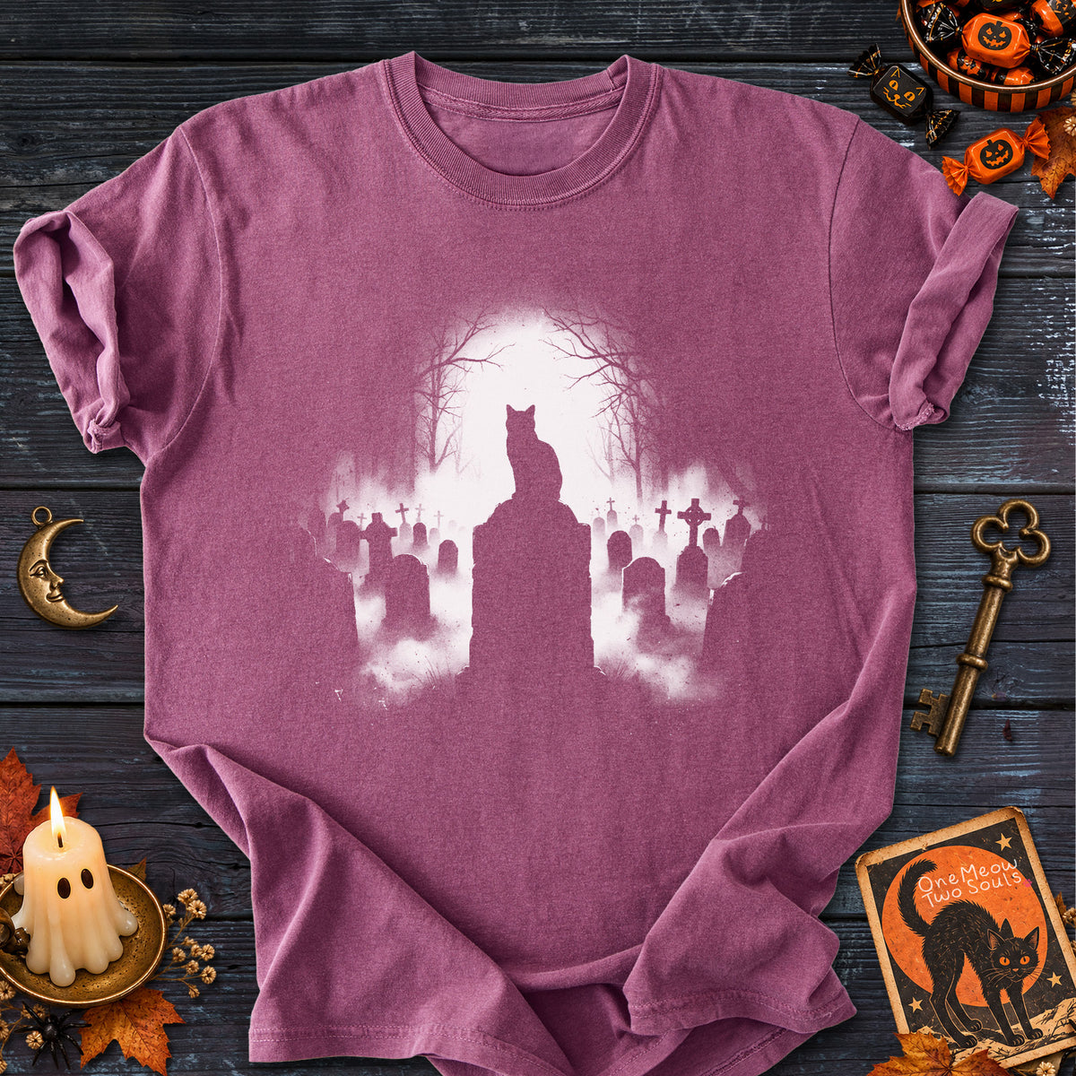 Berry  colored Comfort Colors 1717 cotton T-shirt, featuring a spooky graveyard Halloween cat design illustration. One Meow Two Souls brand.