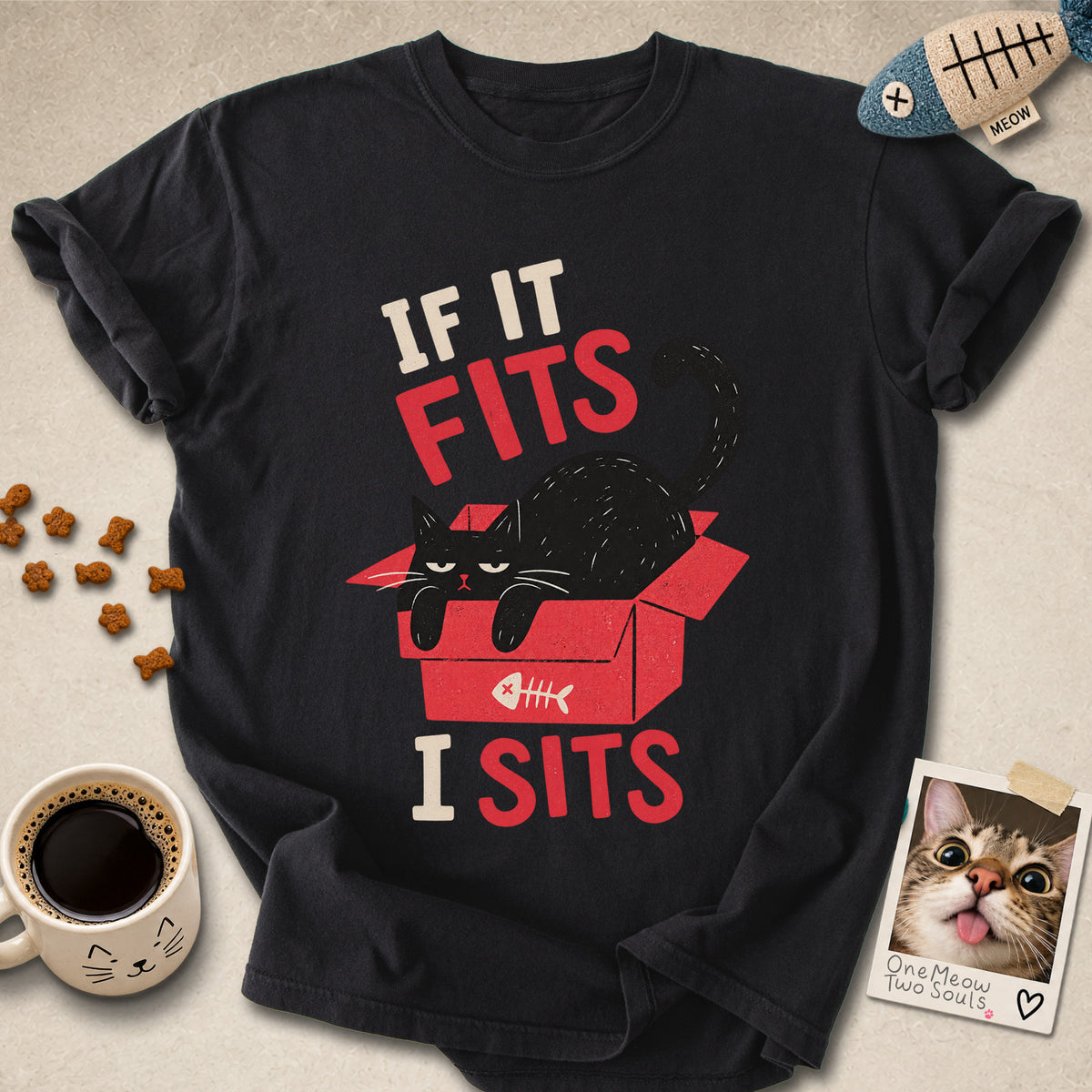 Black colored Comfort Colors 1717 cotton T-shirt, featuring a "If it fitsts I sits" funny cat design illustration. One Meow Two Souls brand.
