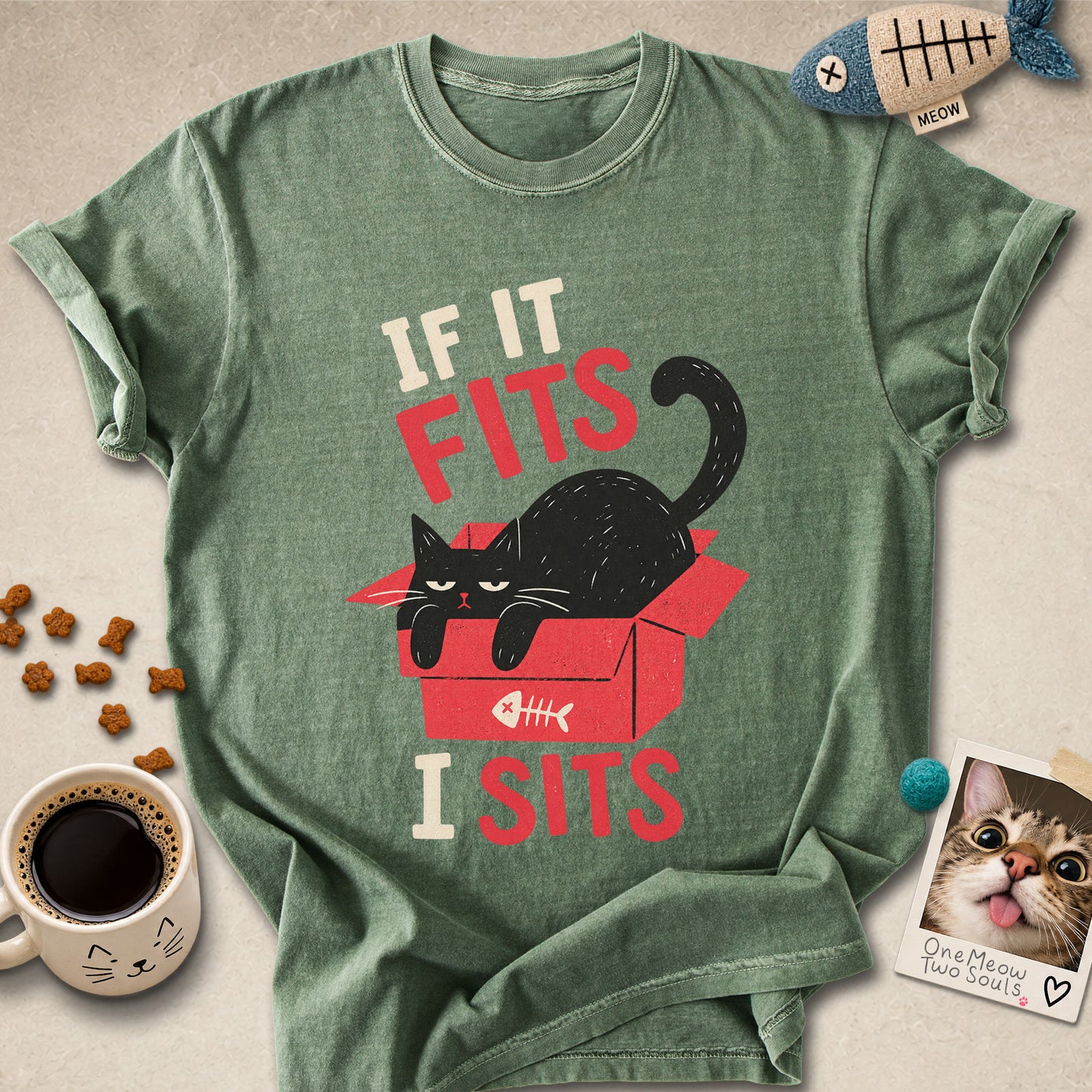 Moss colored Comfort Colors 1717 cotton T-shirt, featuring a "If it fitsts I sits" funny cat design illustration. One Meow Two Souls brand.