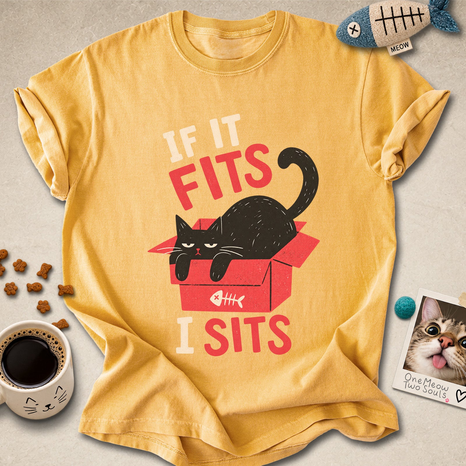 Mustard colored Comfort Colors 1717 cotton T-shirt, featuring a "If it fitsts I sits" funny cat design illustration. One Meow Two Souls brand.