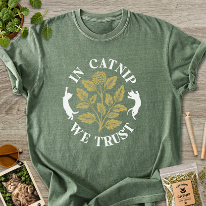 Moss colored Comfort Colors 1717 cotton T-shirt, featuring a "In Catnip We Trust" funny cat design illustration. One Meow Two Souls brand.