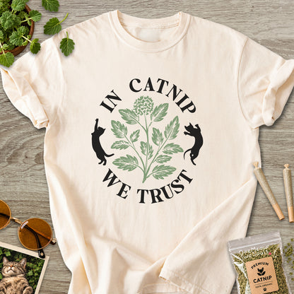 Ivory colored Comfort Colors 1717 cotton T-shirt, featuring a "In Catnip We Trust" funny cat design illustration. One Meow Two Souls brand.