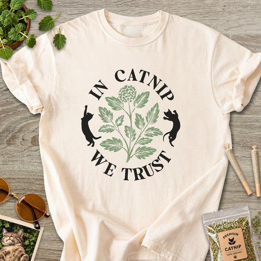 Ivory colored Comfort Colors 1717 cotton T-shirt, featuring a "In Catnip We Trust" funny cat design illustration. One Meow Two Souls brand.