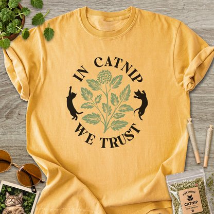 Mustard colored Comfort Colors 1717 cotton T-shirt, featuring a "In Catnip We Trust" funny cat design illustration. One Meow Two Souls brand.