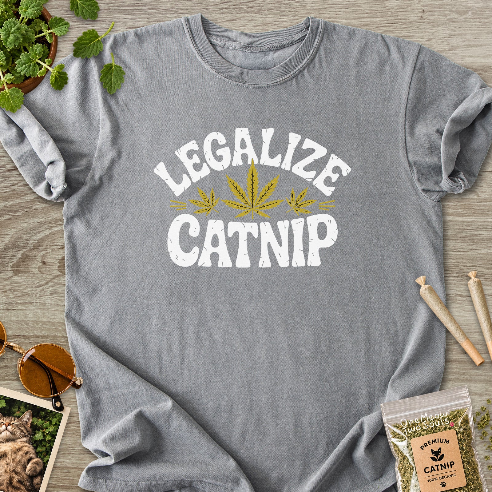 Grey colored Comfort Colors 1717 cotton T-shirt, featuring a "Legalize Catnip" funny cat design illustration. One Meow Two Souls brand.