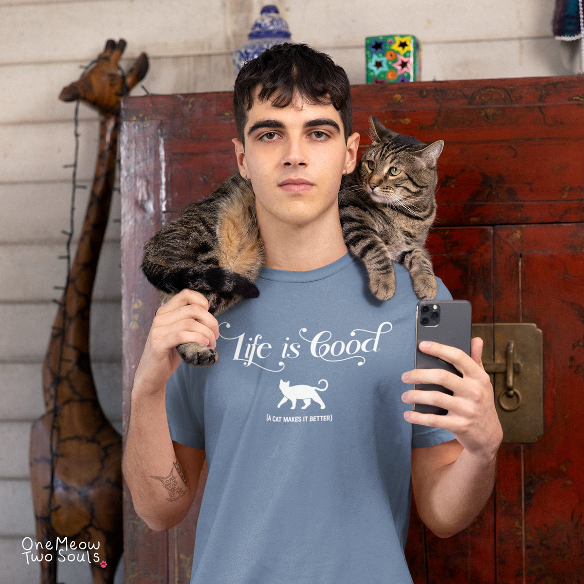 Blue Jean colored Comfort Colors 1717 cotton T-shirt, featuring a "Life is good. A cat makes it better" funny cat design illustration. One Meow Two Souls brand.
