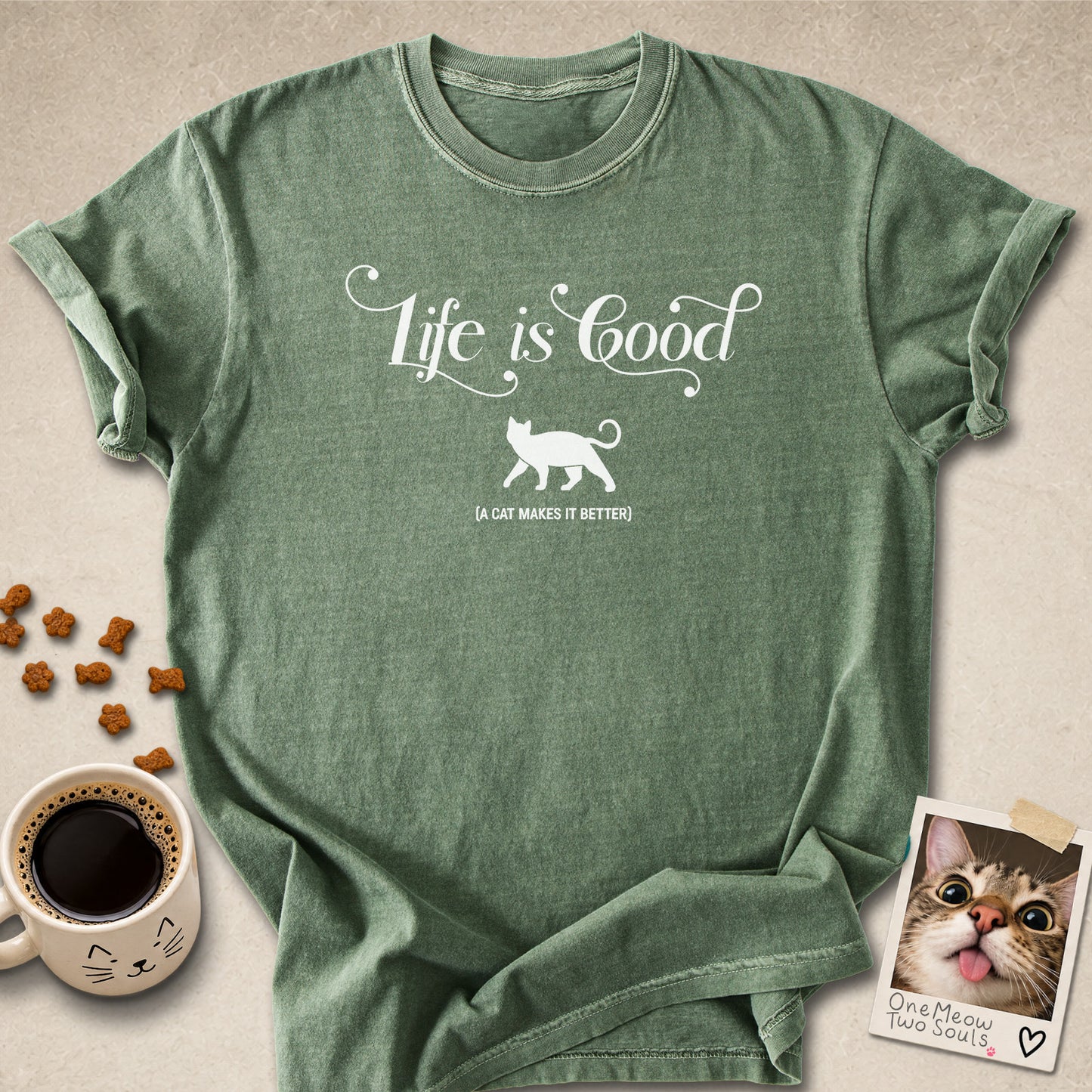 Moss colored Comfort Colors 1717 cotton T-shirt, featuring a "Life is good. A cat makes it better" funny cat design illustration. One Meow Two Souls brand.