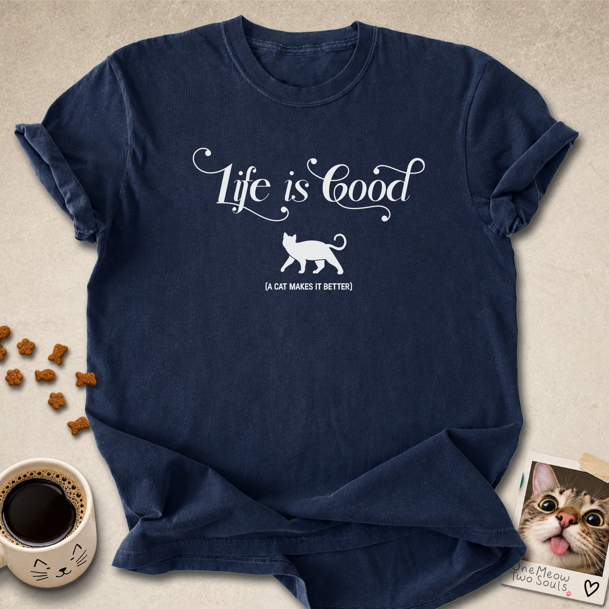 Navy colored Comfort Colors 1717 cotton T-shirt, featuring a "Life is good. A cat makes it better" funny cat design illustration. One Meow Two Souls brand.