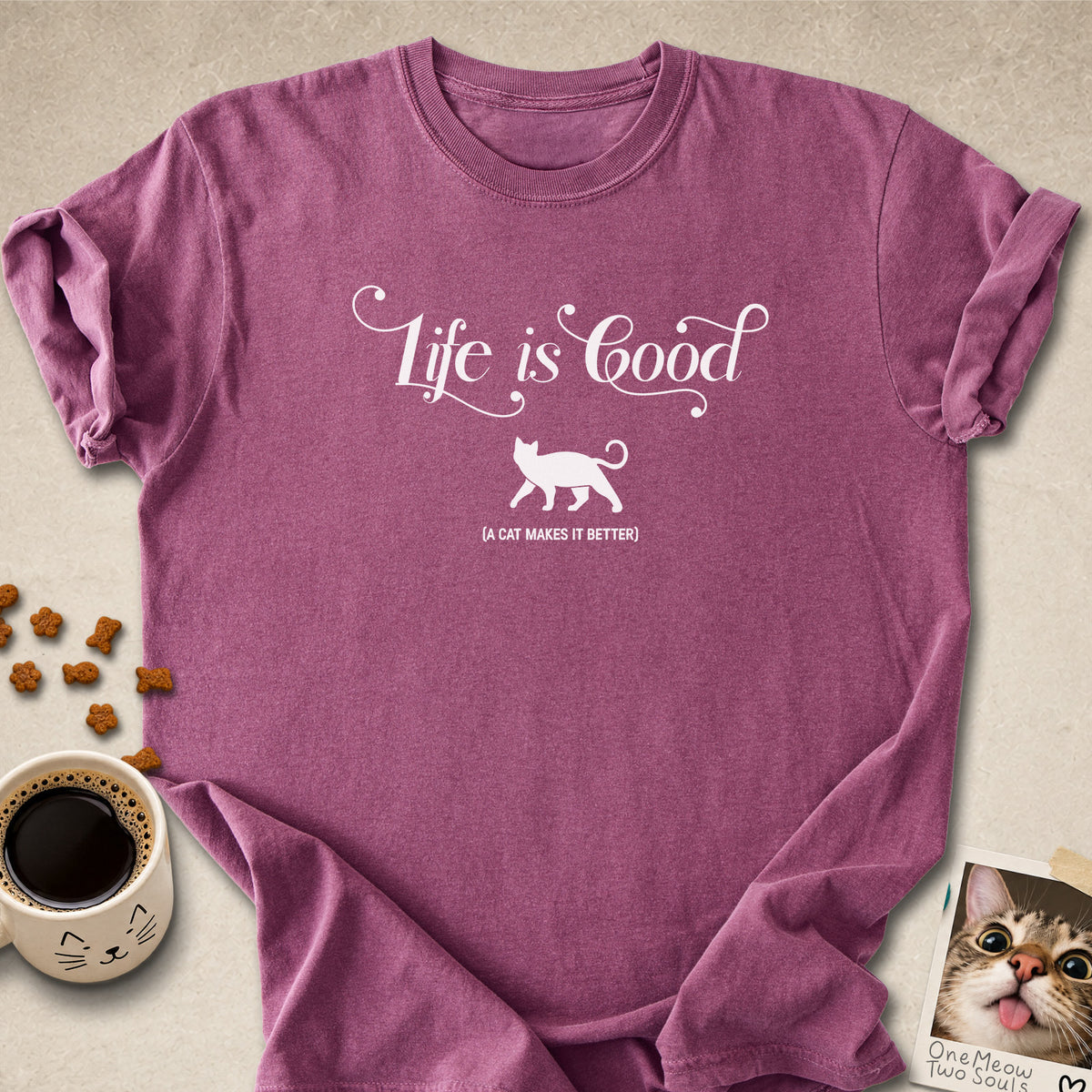 Berry colored Comfort Colors 1717 cotton T-shirt, featuring a "Life is good. A cat makes it better" funny cat design illustration. One Meow Two Souls brand.
