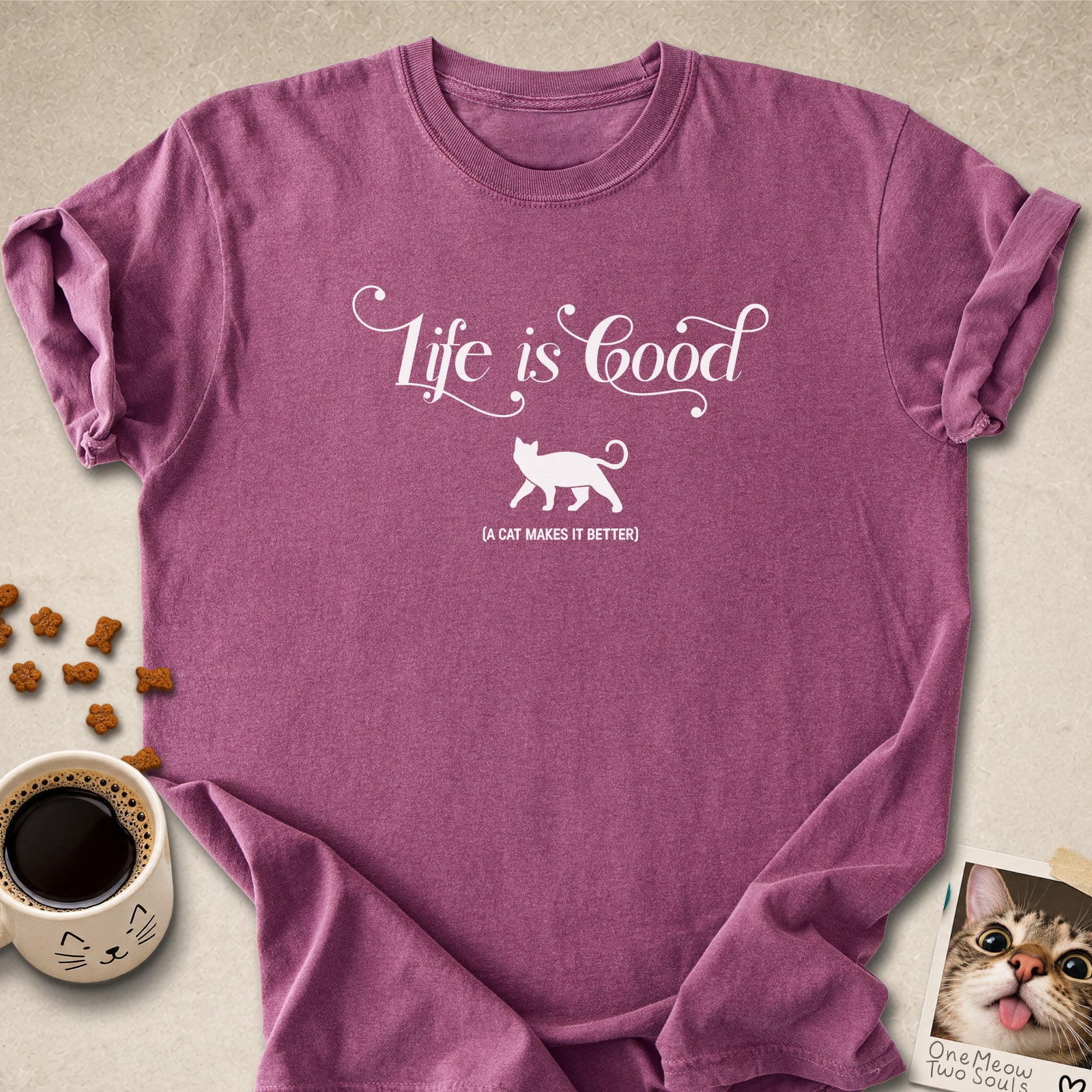 Berry colored Comfort Colors 1717 cotton T-shirt, featuring a "Life is good. A cat makes it better" funny cat design illustration. One Meow Two Souls brand.