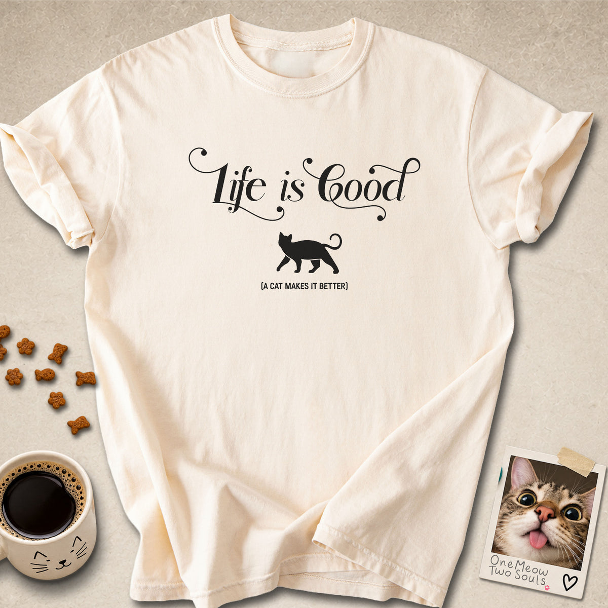 Ivory colored Comfort Colors 1717 cotton T-shirt, featuring a "Life is good. A cat makes it better" funny cat design illustration. One Meow Two Souls brand.