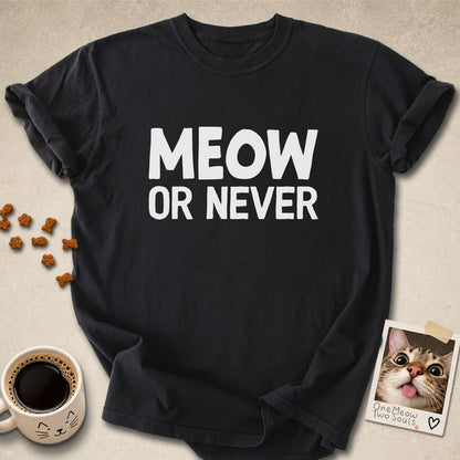 Black colored Comfort Colors 1717 cotton T-shirt, featuring a "Meow Or Never" funny cat design illustration. One Meow Two Souls brand.