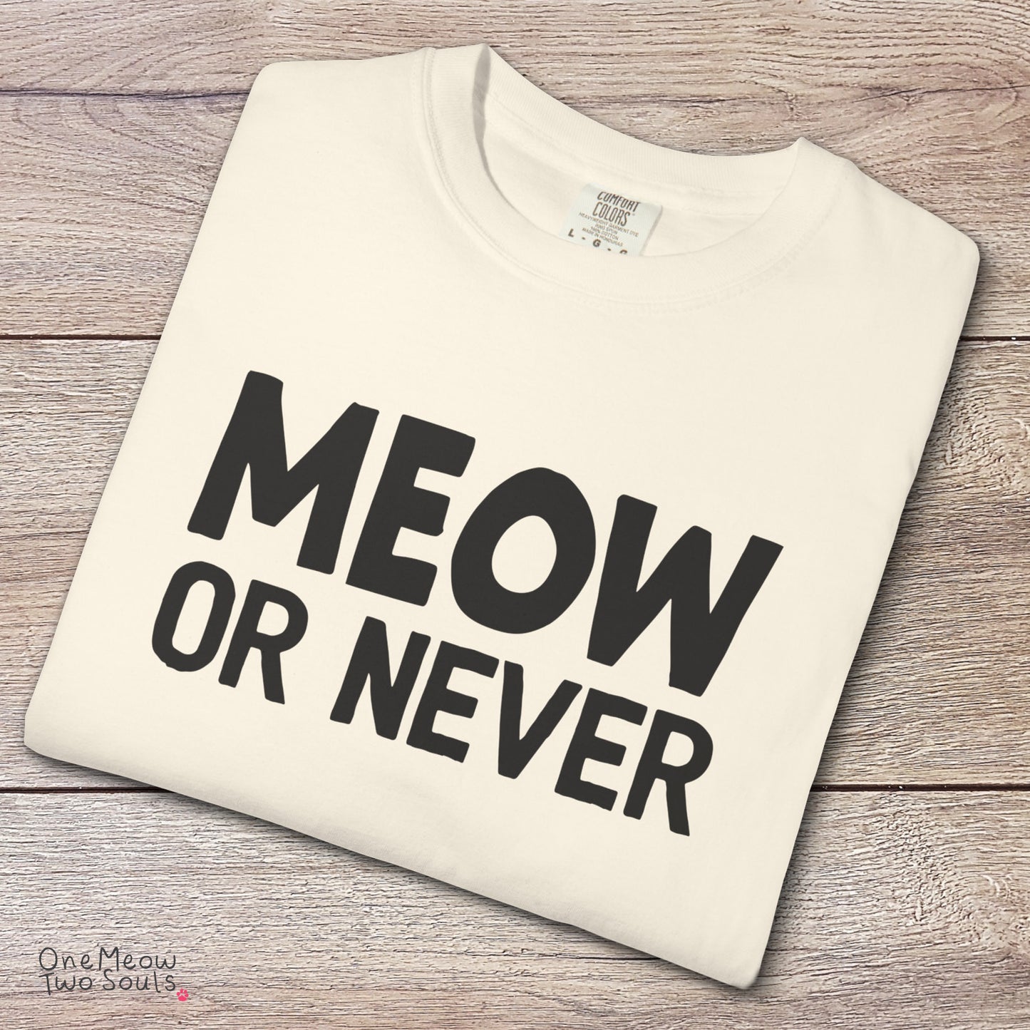 Ivory colored Comfort Colors 1717 cotton T-shirt, featuring a "Meow Or Never" funny cat design illustration. One Meow Two Souls brand.
