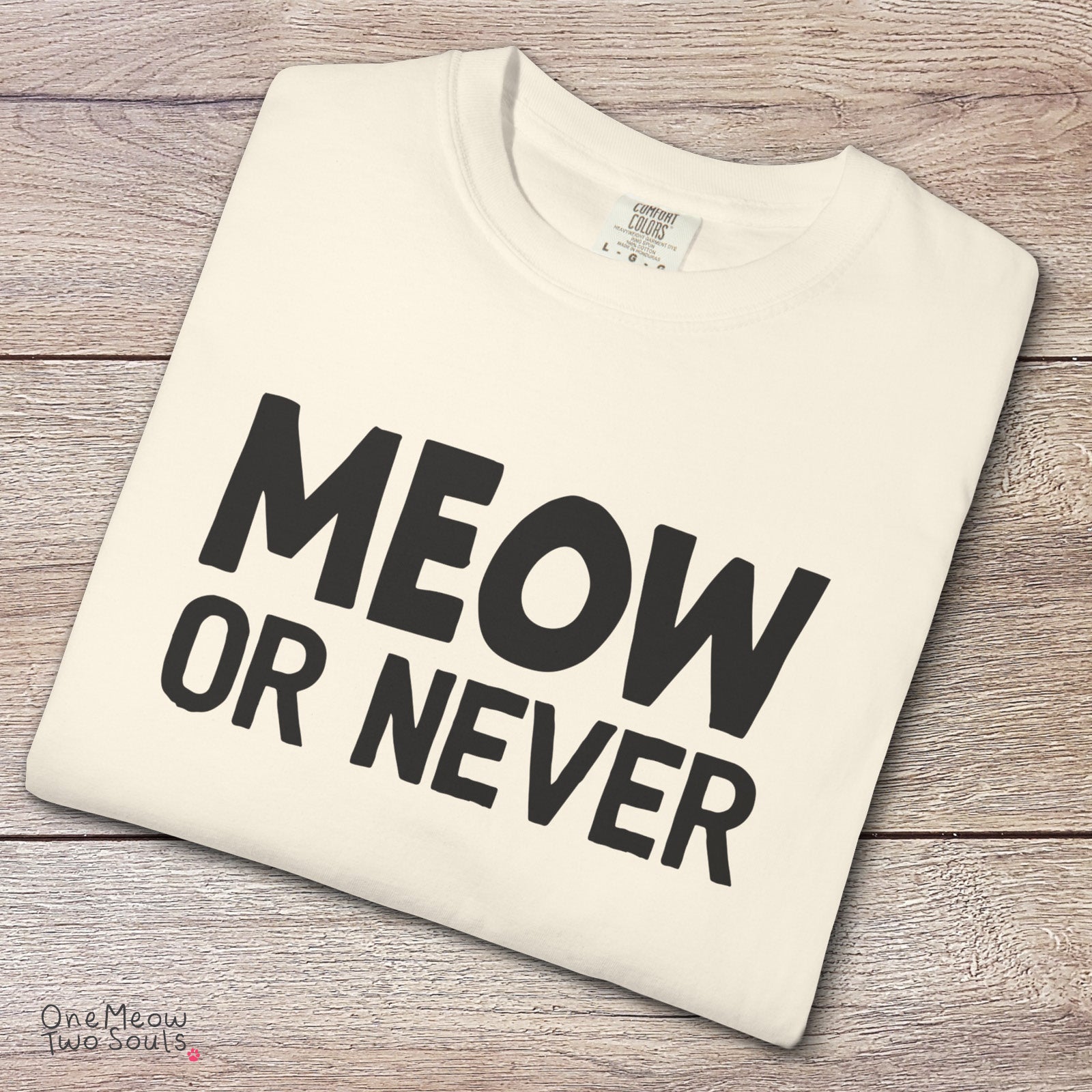 Ivory colored Comfort Colors 1717 cotton T-shirt, featuring a "Meow Or Never" funny cat design illustration. One Meow Two Souls brand.