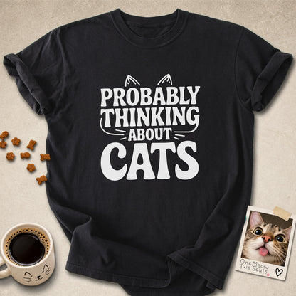 Black colored Comfort Colors 1717 cotton T-shirt, featuring a "Probably thinking about cats" funny cat design illustration. One Meow Two Souls brand.