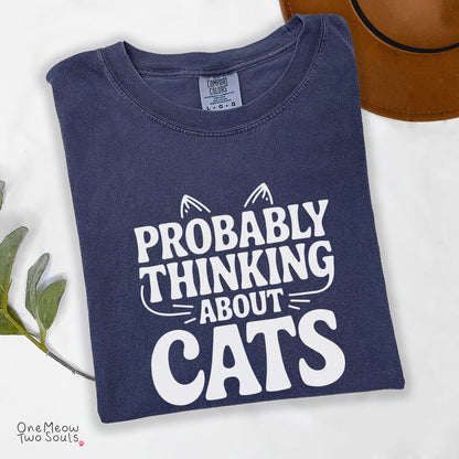 Navy colored Comfort Colors 1717 cotton T-shirt, featuring a "Probably thinking about cats" funny cat design illustration. One Meow Two Souls brand.