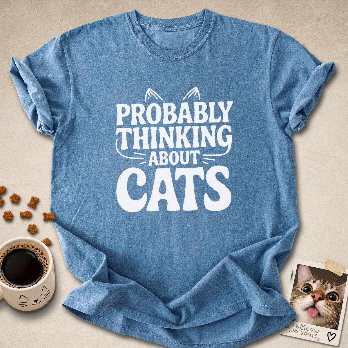 Blue jean colored Comfort Colors 1717 cotton T-shirt, featuring a "Probably thinking about cats" funny cat design illustration. One Meow Two Souls brand.