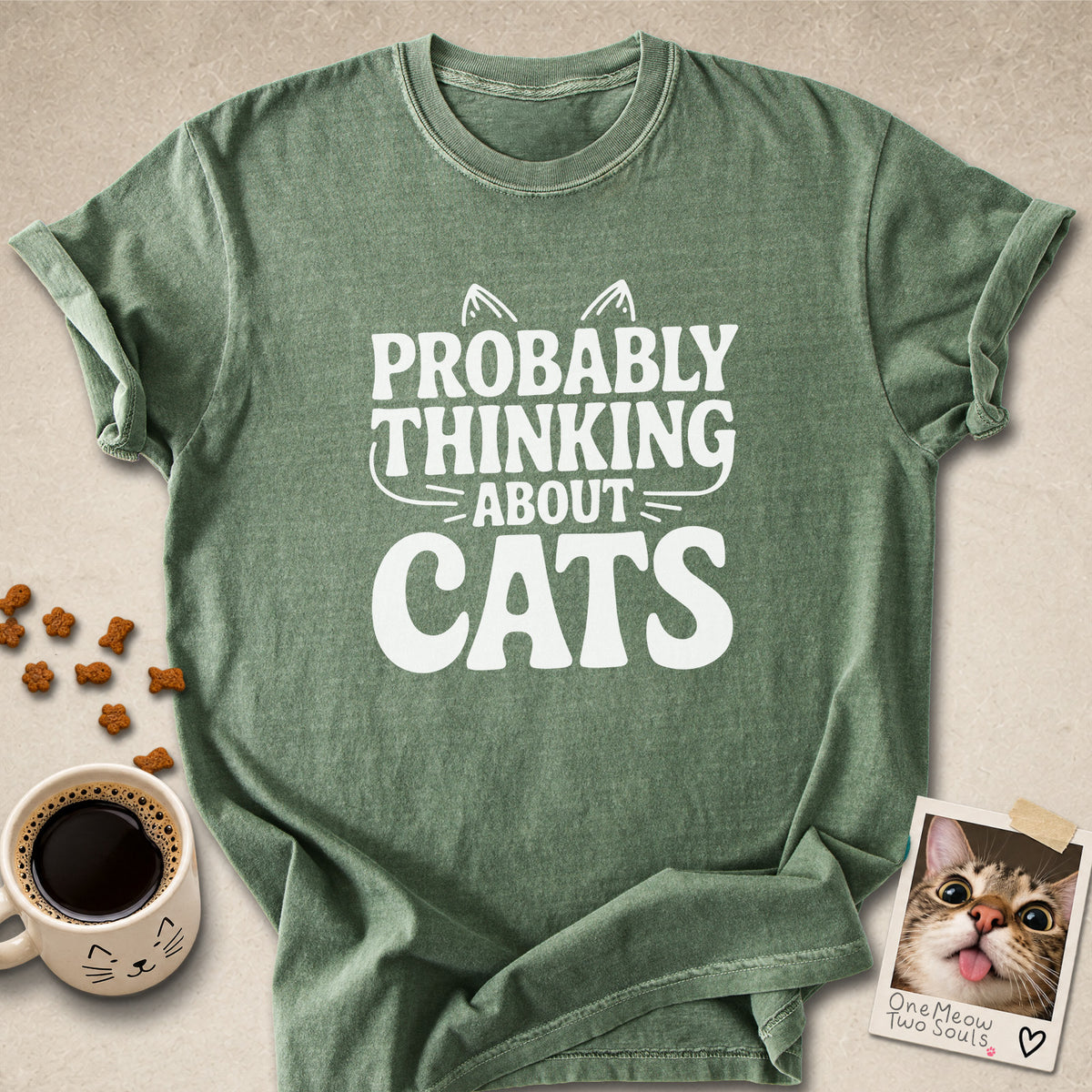Moss colored Comfort Colors 1717 cotton T-shirt, featuring a "Probably thinking about cats" funny cat design illustration. One Meow Two Souls brand.