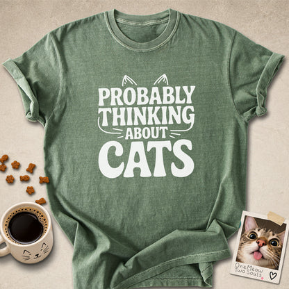 Moss colored Comfort Colors 1717 cotton T-shirt, featuring a "Probably thinking about cats" funny cat design illustration. One Meow Two Souls brand.