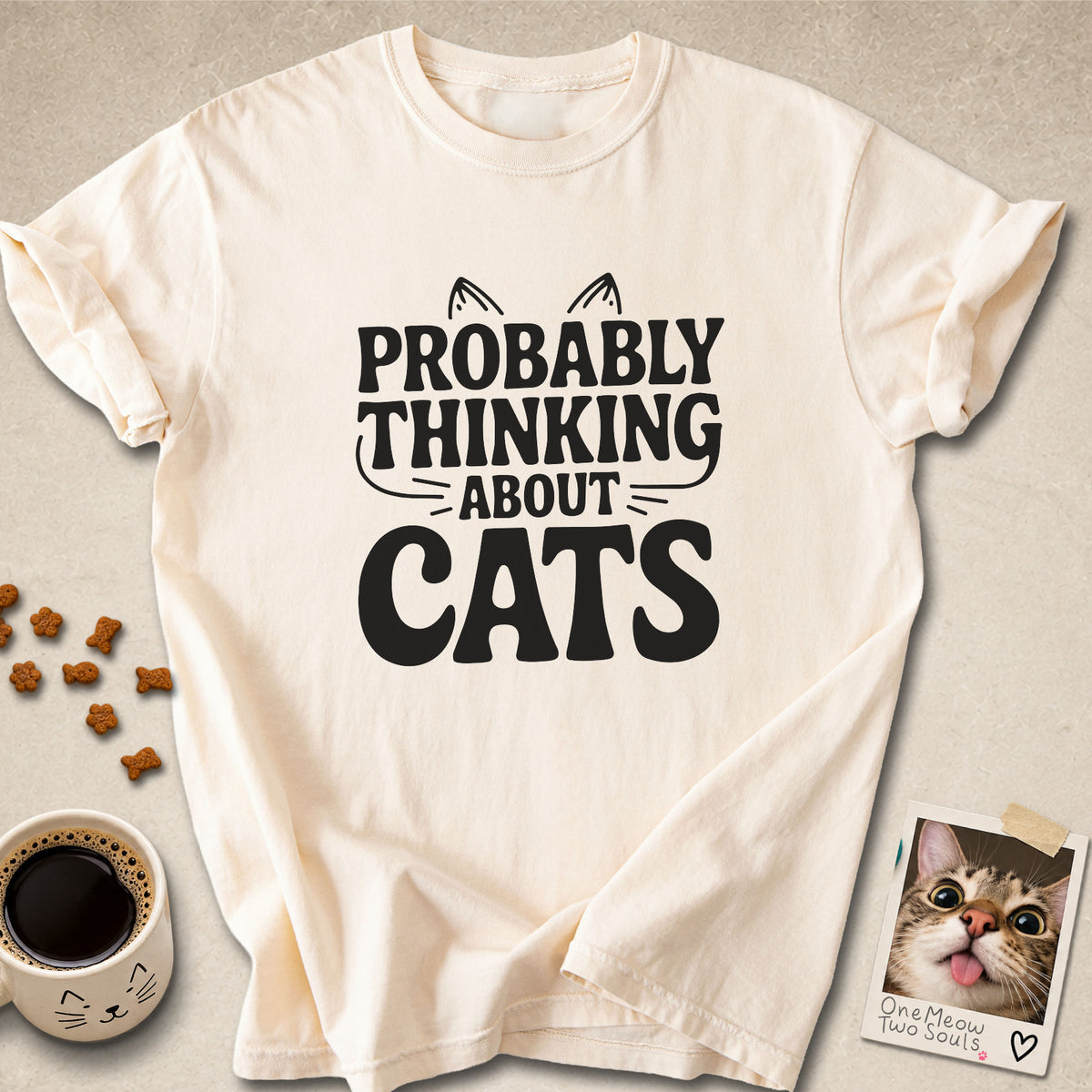 Ivory colored Comfort Colors 1717 cotton T-shirt, featuring a "Probably thinking about cats" funny cat design illustration. One Meow Two Souls brand.