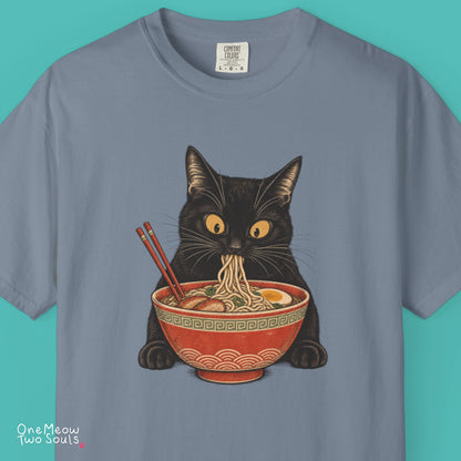 Blue jean colored Comfort Colors 1717 cotton T-shirt, featuring a Black cat eating Japanese ramen noodles. Funny cat design illustration. One Meow Two Souls brand.