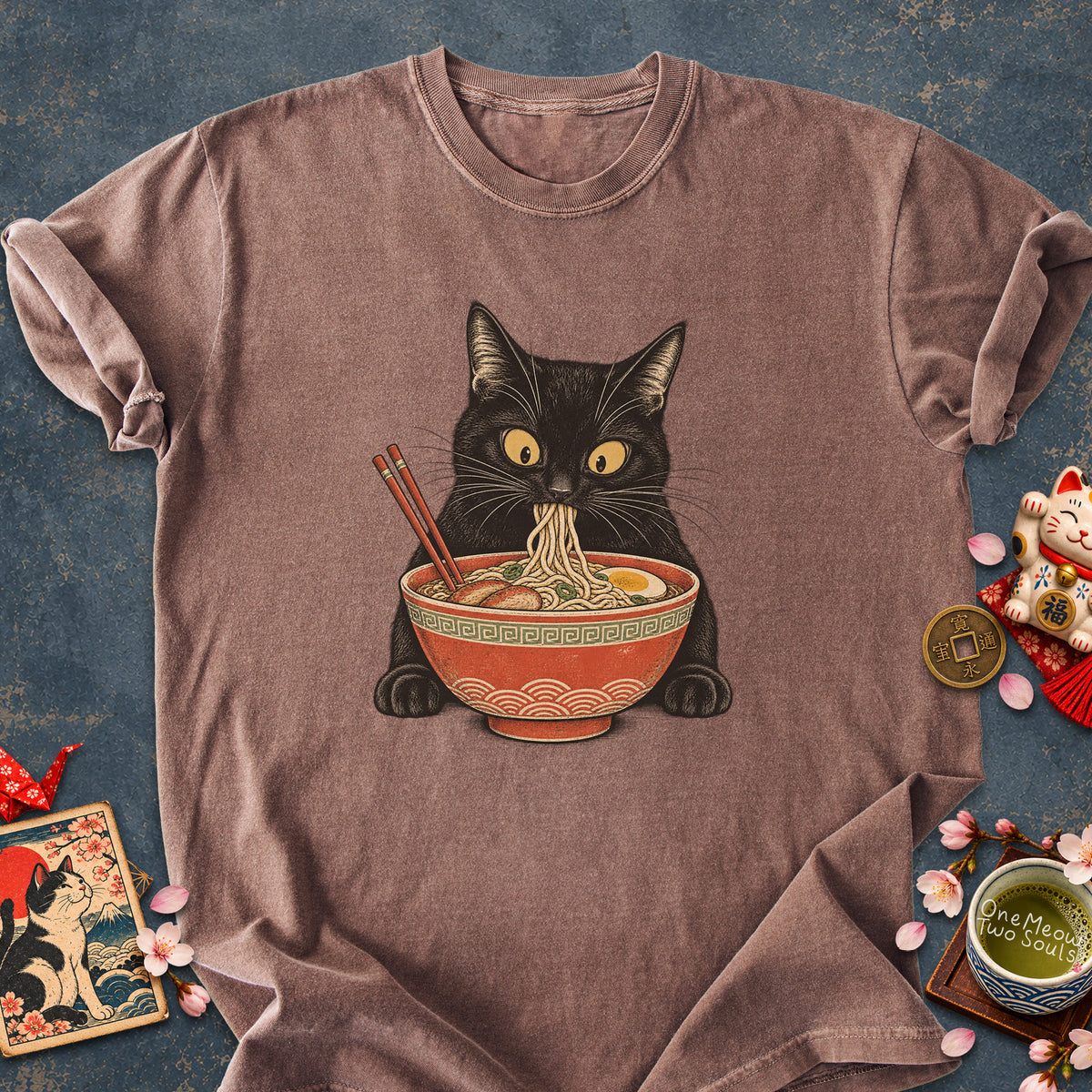 Espresso colored Comfort Colors 1717 cotton T-shirt, featuring a Black cat eating Japanese ramen noodles. Funny cat design illustration. One Meow Two Souls brand.