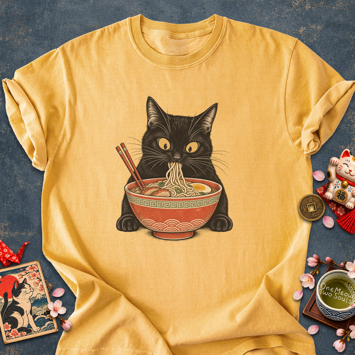 Mustard colored Comfort Colors 1717 cotton T-shirt, featuring a Black cat eating Japanese ramen noodles. Funny cat design illustration. One Meow Two Souls brand.