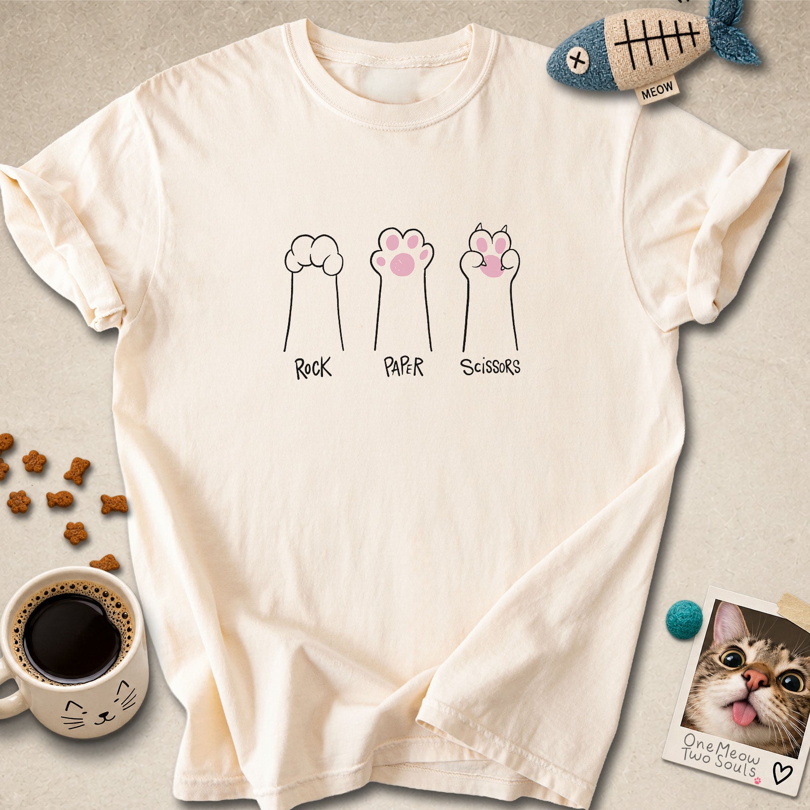 Ivory colored Comfort Colors 1717 cotton T-shirt, presenting a "Rock Paper Scissors" funny cat design. One Meow Two Souls brand.