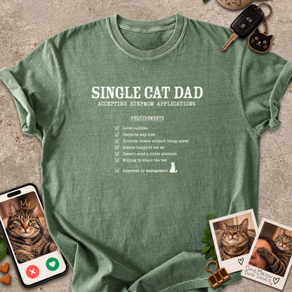 Moss colored Comfort Colors 1717 cotton T-shirt, featuring a "Single cat dad accepting stepmom applications" funny cat design illustration. One Meow Two Souls brand.