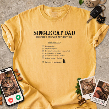Mustard colored Comfort Colors 1717 cotton T-shirt, featuring a "Single cat dad accepting stepmom applications" funny cat design illustration. One Meow Two Souls brand.
