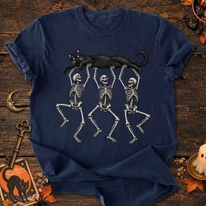 Navy colored Comfort Colors 1717 cotton T-shirt, featuring a Black cat carried by three skeletons funny cat Halloween design illustration. One Meow Two Souls brand.