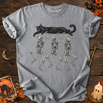 Gray colored Comfort Colors 1717 cotton T-shirt, featuring a Black cat carried by three skeletons funny cat Halloween design illustration. One Meow Two Souls brand.