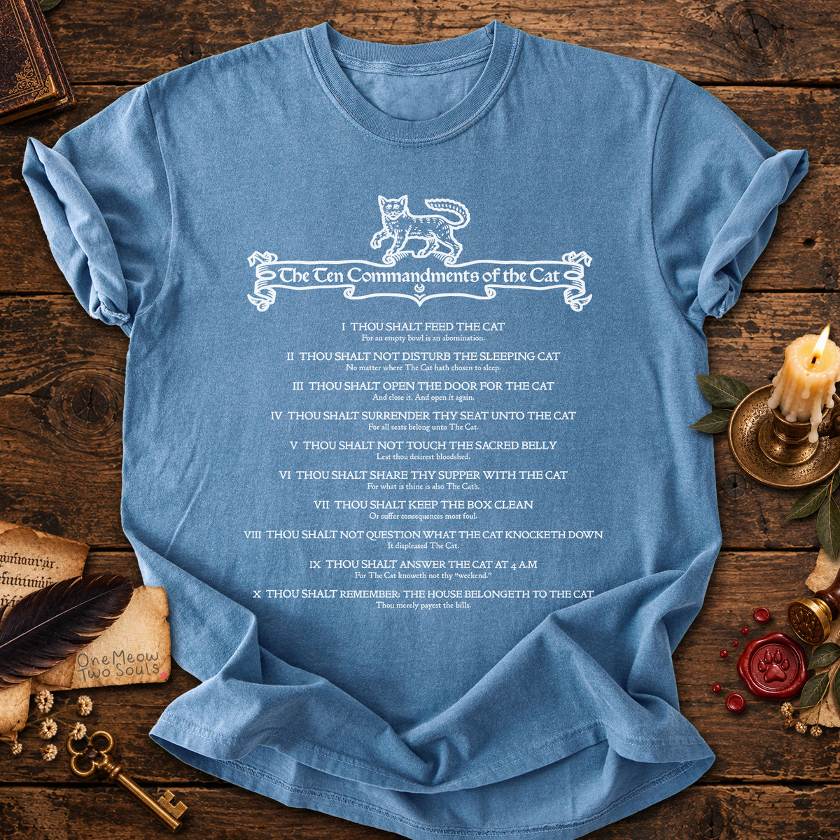 Blue Jean colored Comfort Colors 1717 cotton T-shirt, featuring a "The Ten Commandments of the Cat" funny cat design illustration. One Meow Two Souls brand.