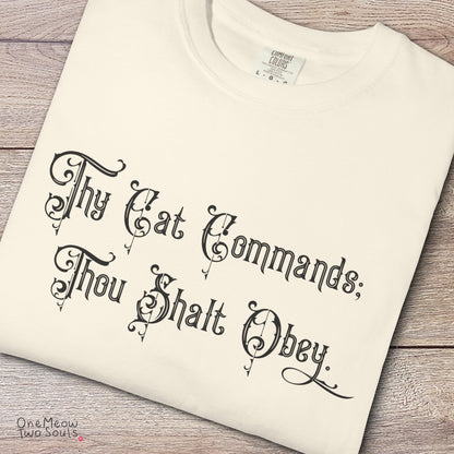 Ivory colored Comfort Colors 1717 cotton T-shirt, featuring a "Thy Cat Commands. Thou Shalt Obey" funny cat design illustration. One Meow Two Souls brand.