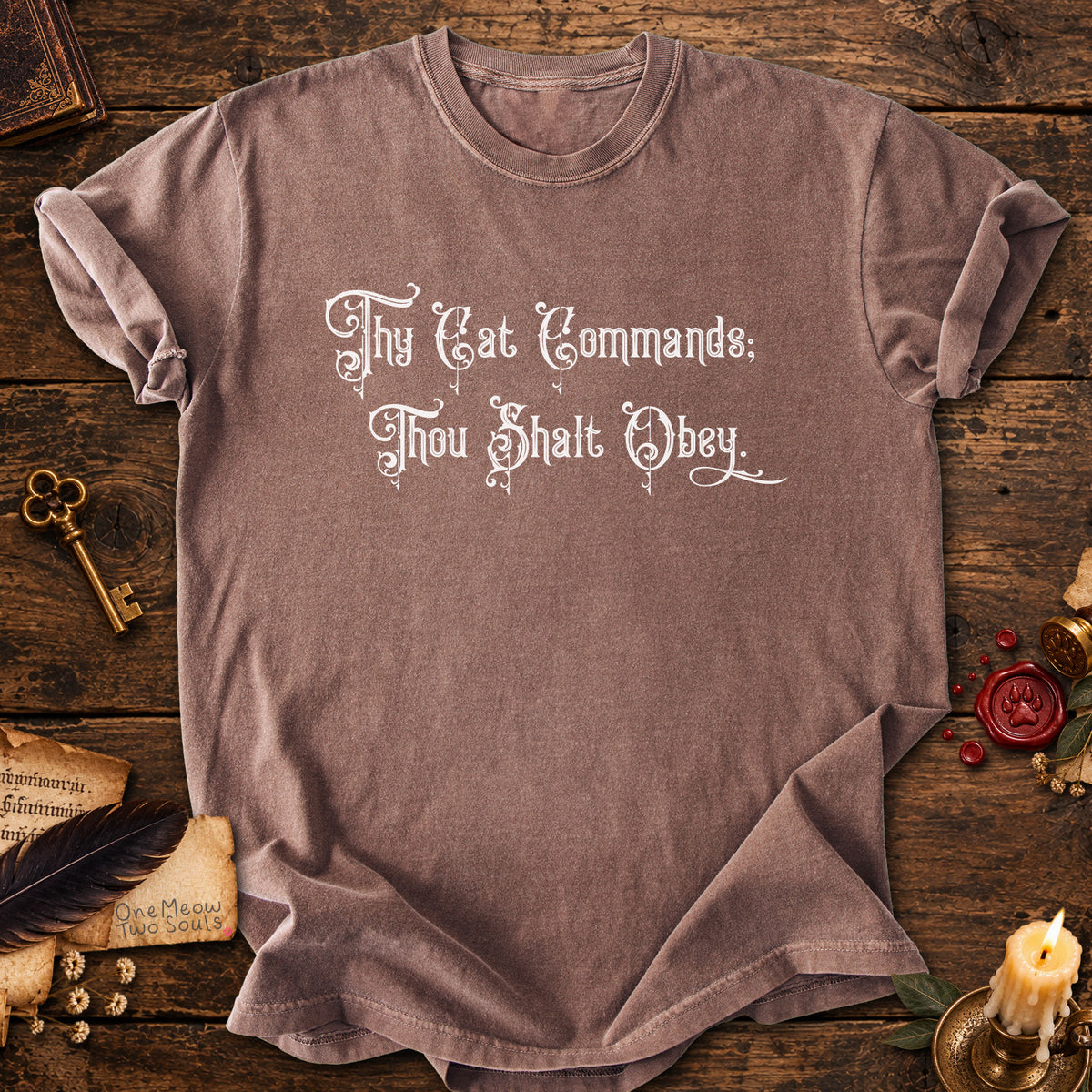 Espresso colored Comfort Colors 1717 cotton T-shirt, featuring a "Thy Cat Commands. Thou Shalt Obey" funny cat design illustration. One Meow Two Souls brand.