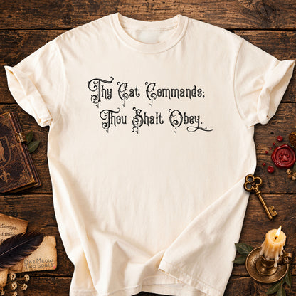 Ivory colored Comfort Colors 1717 cotton T-shirt, featuring a "Thy Cat Commands. Thou Shalt Obey" funny cat design illustration. One Meow Two Souls brand.