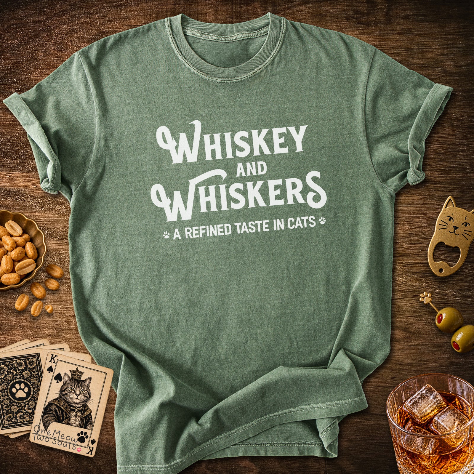 Moss colored Comfort Colors 1717 cotton T-shirt, with a "Whiskey and Whiskers" design. One Meow Two Souls brand.