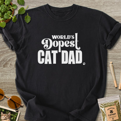Black colored Comfort Colors 1717 cotton T-shirt, featuring a "World's Dopest Cat Dad" funny cat design illustration. One Meow Two Souls brand.