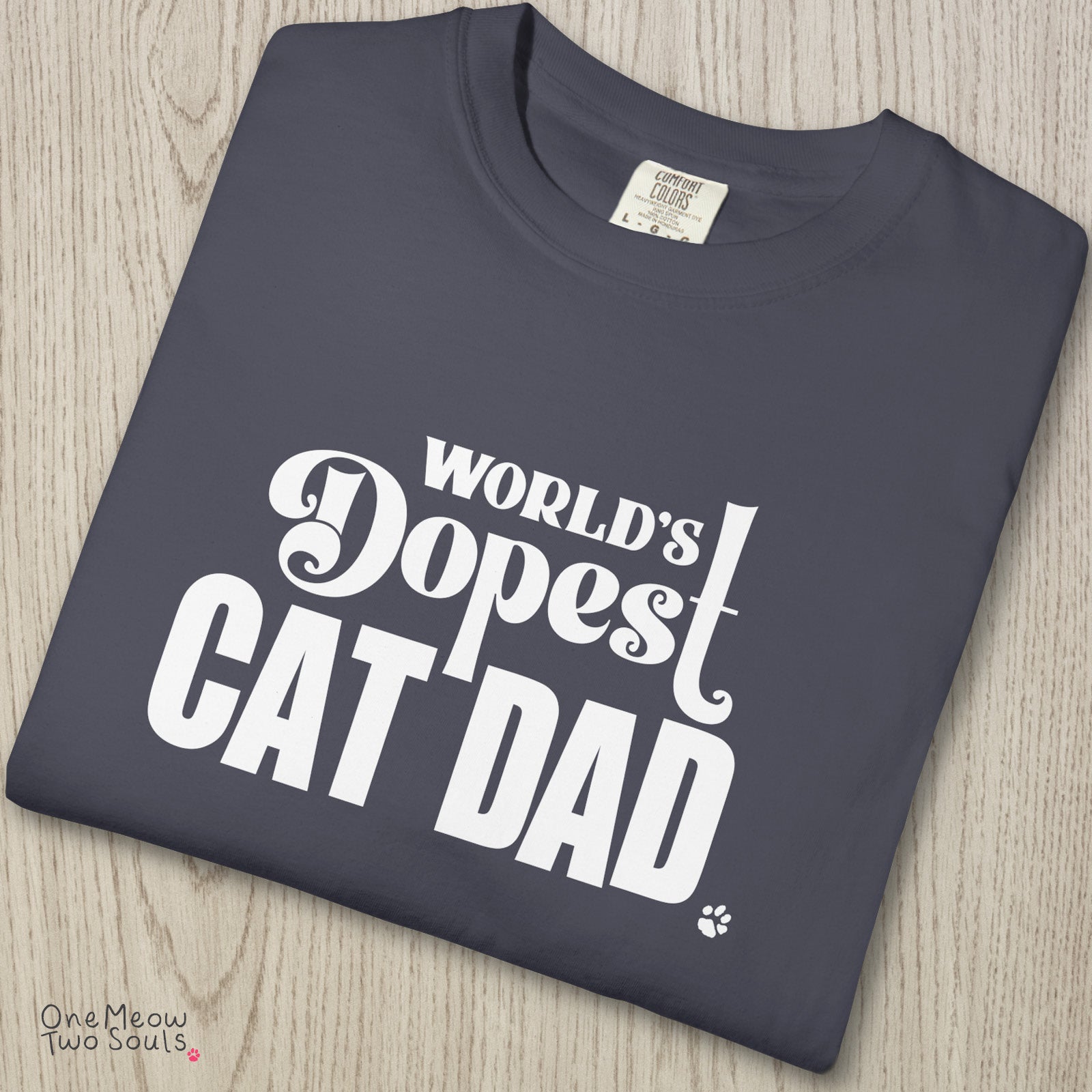 Navy colored Comfort Colors 1717 cotton T-shirt, featuring a "World's Dopest Cat Dad" funny cat design illustration. One Meow Two Souls brand.