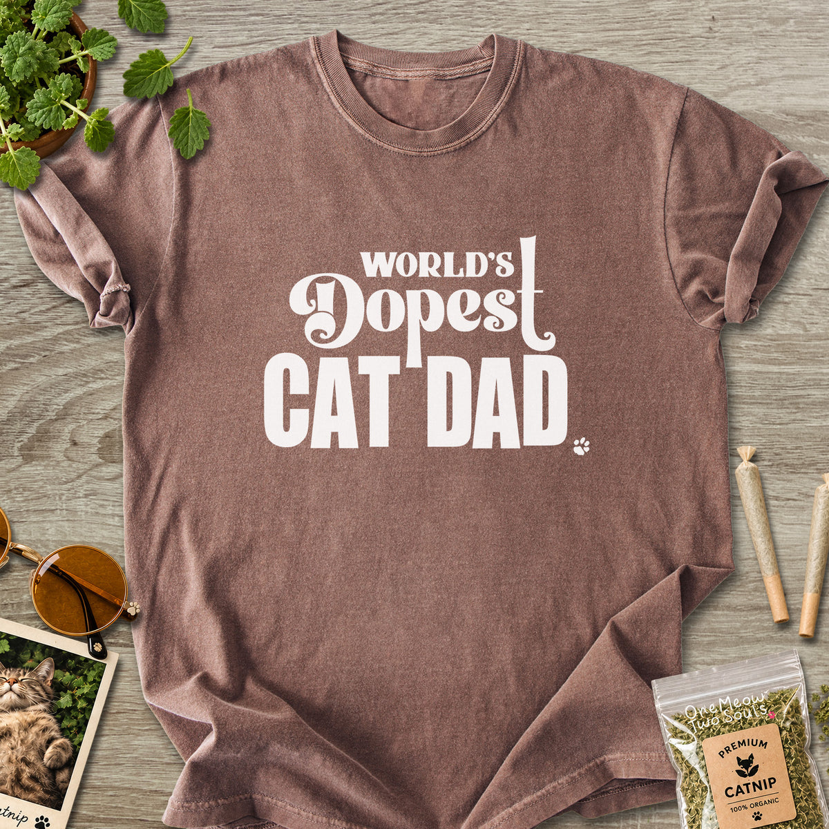 Espresso colored Comfort Colors 1717 cotton T-shirt, featuring a "World's Dopest Cat Dad" funny cat design illustration. One Meow Two Souls brand.