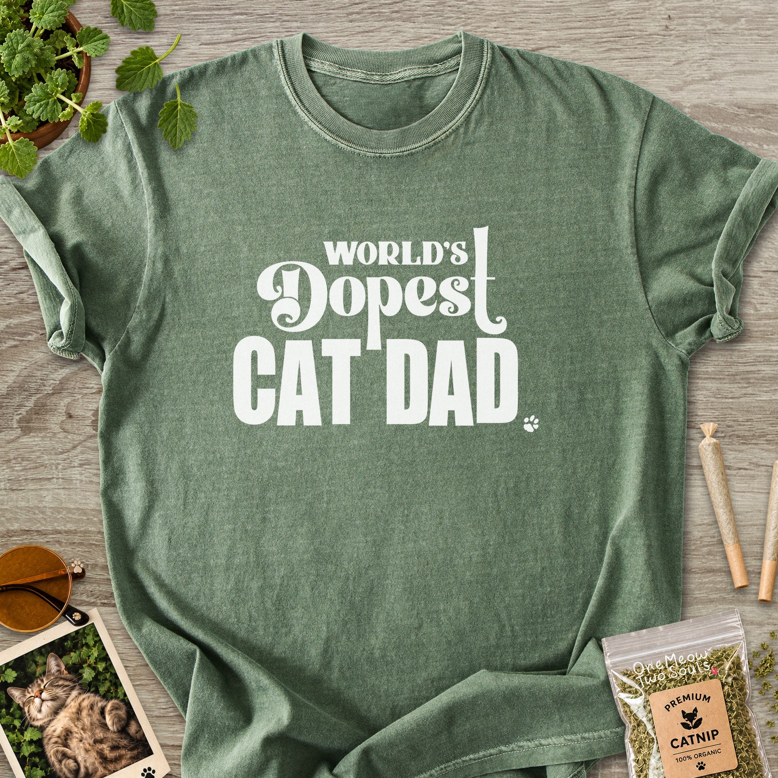 Moss colored Comfort Colors 1717 cotton T-shirt, featuring a "World's Dopest Cat Dad" funny cat design illustration. One Meow Two Souls brand.