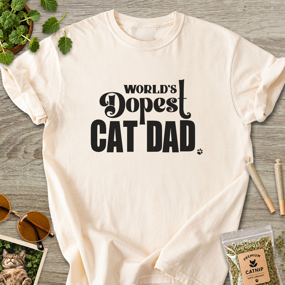 Ivory colored Comfort Colors 1717 cotton T-shirt, featuring a "World's Dopest Cat Dad" funny cat design illustration. One Meow Two Souls brand.