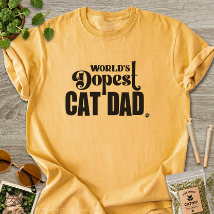 Mustard colored Comfort Colors 1717 cotton T-shirt, featuring a "World's Dopest Cat Dad" funny cat design illustration. One Meow Two Souls brand.