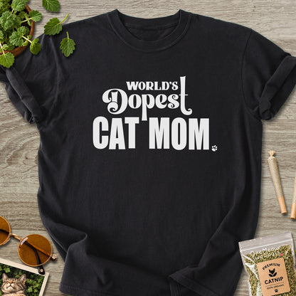 Black colored Comfort Colors 1717 cotton T-shirt, featuring a "World's Dopest Cat Mom" funny cat design illustration. One Meow Two Souls brand.