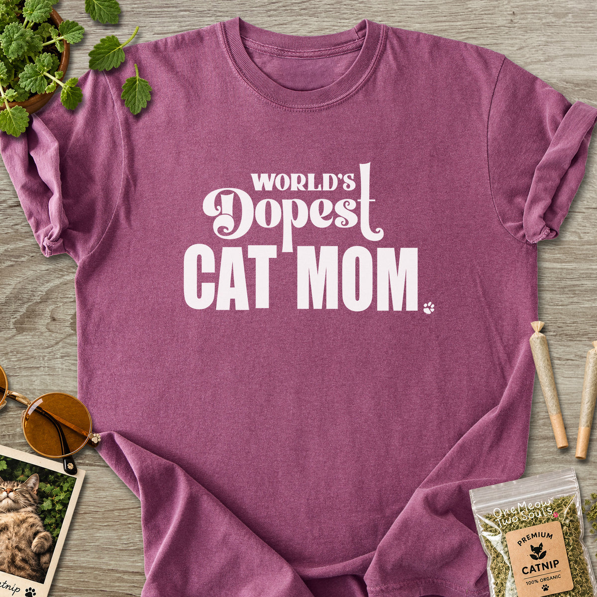 Berry colored Comfort Colors 1717 cotton T-shirt, featuring a "World's Dopest Cat Mom" funny cat design illustration. One Meow Two Souls brand.