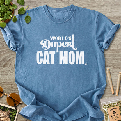 Blue Jean colored Comfort Colors 1717 cotton T-shirt, featuring a "World's Dopest Cat Mom" funny cat design illustration. One Meow Two Souls brand.
